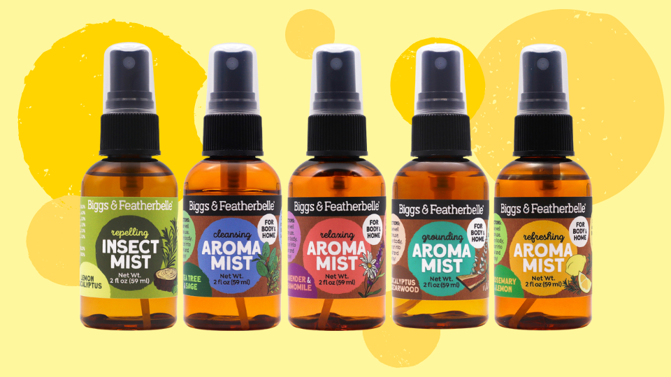Five bottles of Aroma Mist sprays by Biggs & Featherbelle on a yellow background
