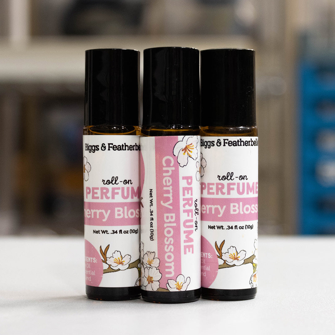 Three roll-on perfume oil bottles labeled &
