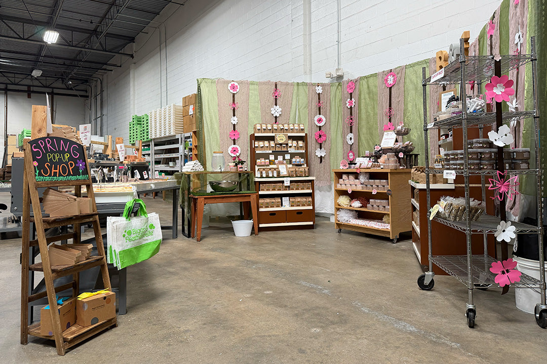 Indoor setting with various displays and products, including a chalkboard sign and shelves.